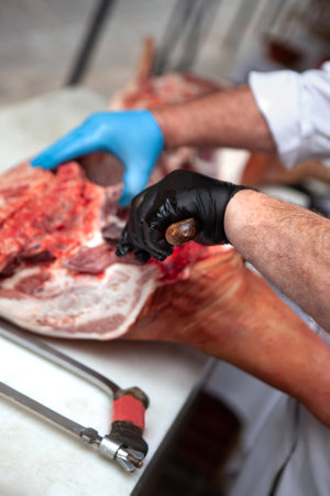 Butcher cutting a piece of pork on a stallの写真素材
