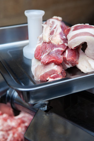 Pork meat on an electric mincerの写真素材