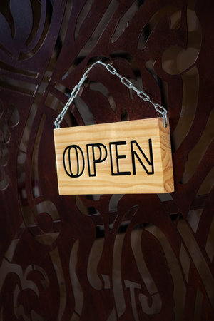 Open sign on a wrought iron door