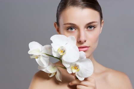 Beautiful fashion model studio holding yellow flowerの写真素材