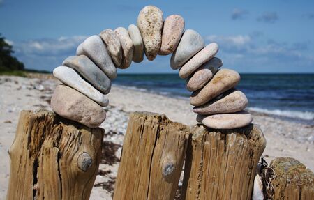 arch of pebbles on beach, Enebaerodde, island Fyn, Denmarkの写真素材
