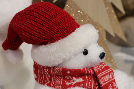 Christmas decoration for children of cute white polar bear with red knitted hat and scarfの写真素材