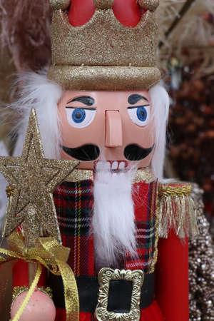 Nutcracker king doll for christmas decoration with gold glitter star and crownの写真素材