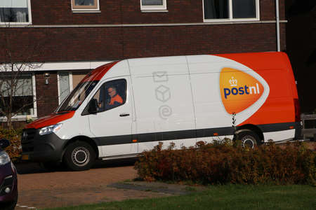 PostNL parcel delivery from in dutch street in Grootebroek, the Netherlands, October 2021のeditorial素材