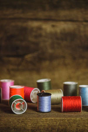 Set of Multi-Colored Sewing Spools on Wood Backgroundの写真素材