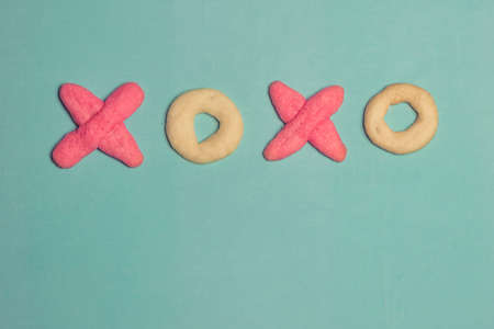 XO Cookies Typography on Pastel Blue Backgroundの写真素材