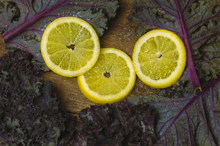 Sliced Lemon and Kale Salad on Wood Backgroundの写真素材