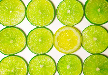 Group of Green Lime Slices with One Standout Lemon Sliceの写真素材