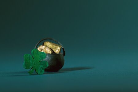 Pot of Gold and Wooden Four-Leaf  Clover on Turquoise Backgroundの写真素材