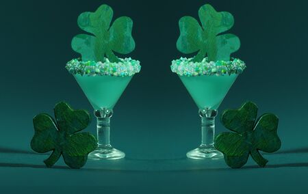Two Irish themed Green, Sugar Rimmed, Confetti Cocktail with Wooden Shamrockの写真素材