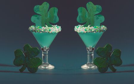 Two Irish themed Green, Sugar Rimmed, Confetti Cocktail with Wooden Shamrockの写真素材
