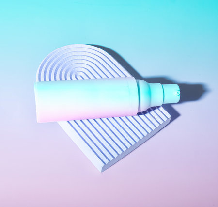 Beauty Serum Lotion Pump on Dreamy Gradient Background in Pastel Colorsの写真素材