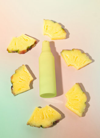 Slices of Fruit Pineapple Slices with Beauty Serum Lotion Bottle, Top Lay, Flat Lay, Beauty and Cosmetics Close Up Shot in Pastel Colorsの写真素材