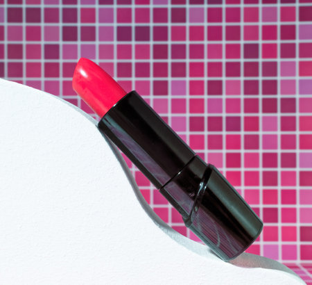 A Tube of Red Lipstick on Bathroom on Wavy Abstract Backdrop, Beauty and Cosmetics Close Up Shot in Redの写真素材