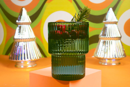 A Holiday Cocktail in A Green Glass with a Sixties Mod Background, Retro Holiday, Christmas Treesの写真素材