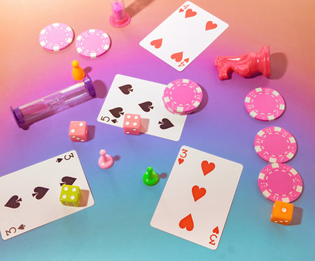 Game Night Top view Scene with Poker Chips, Playing Cards, Chess Pieces, Dice, Gaming Sand Timers and Board game Pawns on a Pastel Pink & Blue Background onの写真素材