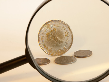 old coins watched by the magnifying glassの写真素材