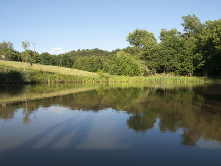 the landscape with the pond  into the sunny dayの写真素材
