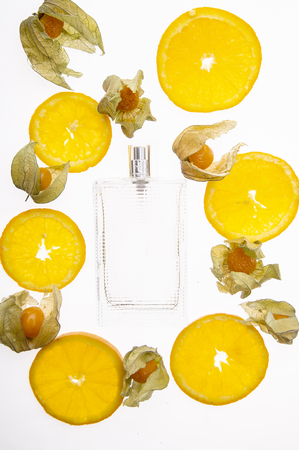 Citrus perfumes, refreshing fruity perfumes. Fruit orange background and perfume bottleの写真素材