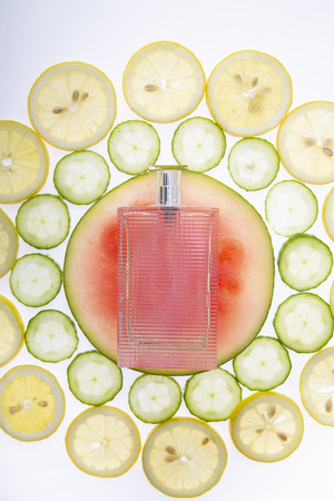 Juicy fruity, fresh perfume, background with a perfume bottle.の写真素材