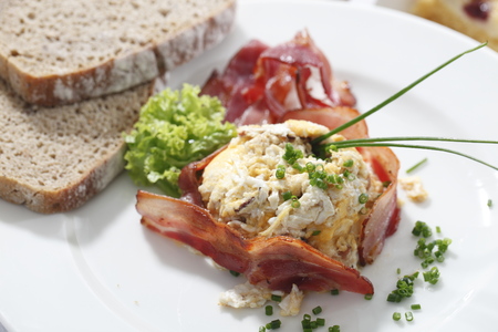 Appetizing breakfast, fried eggs, bacon and breadの写真素材