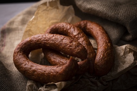 A bunch of dry, smoked sausage on an ecological rural natural background.の写真素材