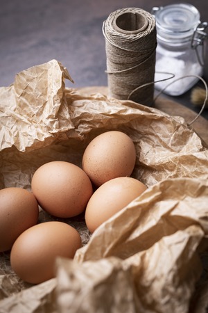 Composition of chicken eggs. Eggs arranged in brown paperの写真素材