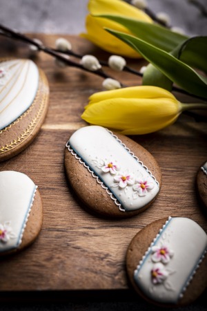 Easter cookies and spring decorations on a wooden backgroundの写真素材