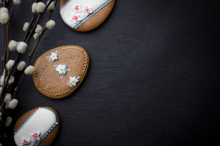 Easter black background with decorative butter cookies with icing and spring decorationsの写真素材