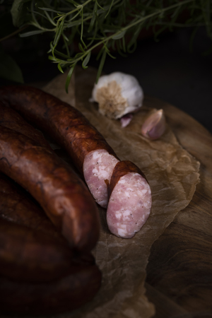 A bunch of dry, smoked sausage on an ecological rural natural background.の写真素材