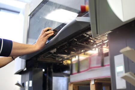 Work in a printing house, operation of printing machinesの写真素材