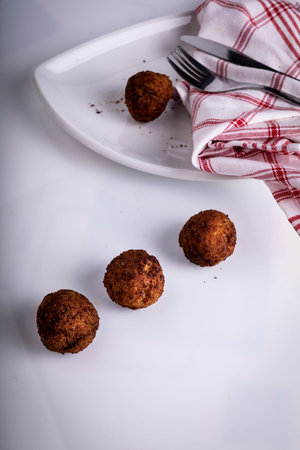 Gold appetizing homemade meatballs with pork on the kitchen table.