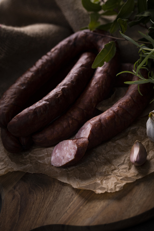 A bunch of dry, smoked sausage on an ecological rural natural background.の写真素材