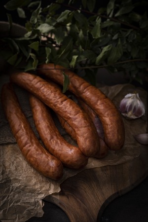 A bunch of dry, smoked sausage on an ecological rural natural background.の写真素材