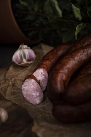 A bunch of dry, smoked sausage on an ecological rural natural background.の写真素材