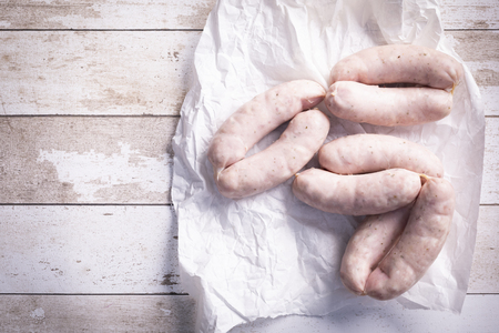 Composition of raw white sausage . Food arranged on a wooden table. Horizontal composition.の写真素材