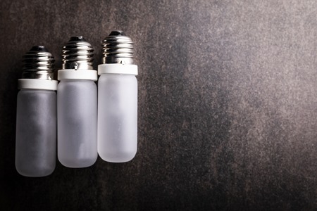 Composition of light bulbs on a dark background, horizontal composition with space for text.の写真素材