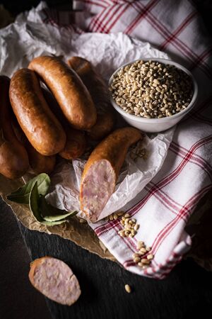 A thin pork sausage in composition with herbsの写真素材
