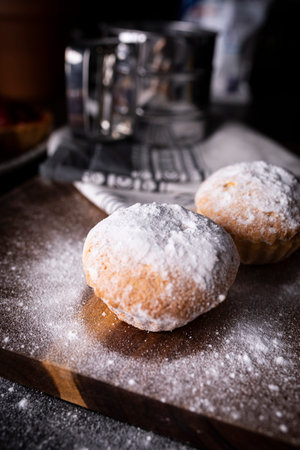 Sweet muffins with cream on a dark background.Composition with space for text