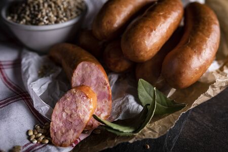 A thin pork sausage in composition with herbsの写真素材