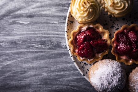 Sweet muffins with cream on a dark background.Composition with space for textの写真素材