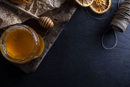 Sweet golden honey in composition with orange and bread.の写真素材
