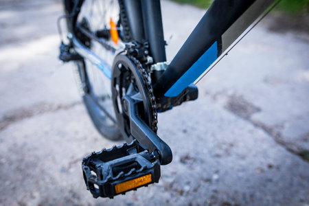 Parts of the bicycle in close-up on the pedal and rear wheel of the bicycle.