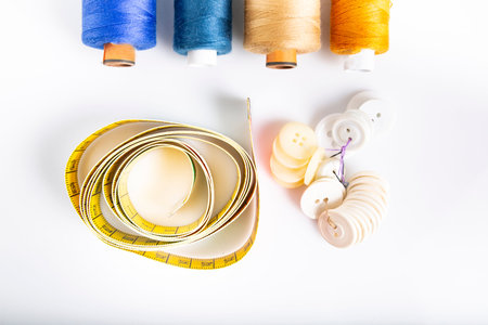 Composition of sewing utensils on a white background. Top view