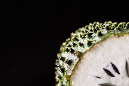 Ripe tropical fruit on a black background.の写真素材