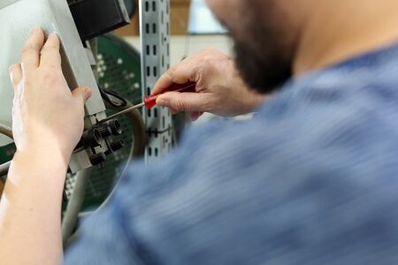 The employee repairs the printing press.の写真素材