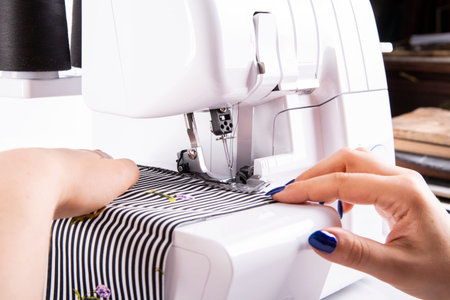 The woman sews on a sewing machine.
