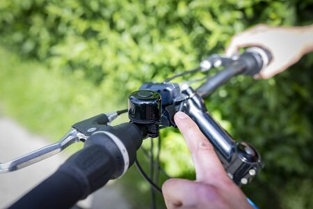 A man's hand while inserting the gears on the handlebar of the bikeの写真素材