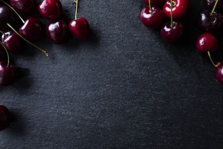 Composition of ripe cherry fruit on a dark background, top viewの写真素材