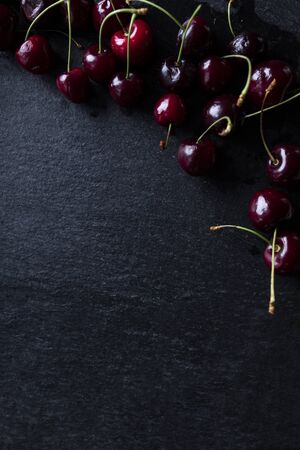Juicy cherries. Cherries on a black background.の写真素材